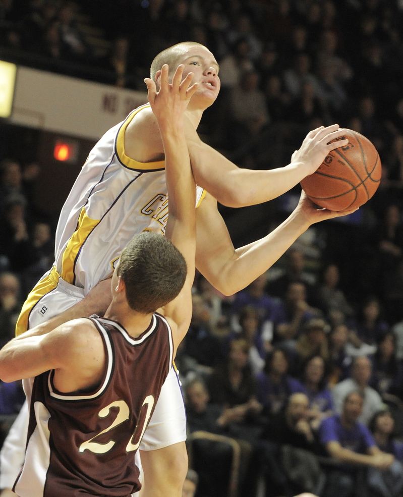 Edward Little's Bo Leary draws an offensive foul against Cam Olsen of Cheverus.