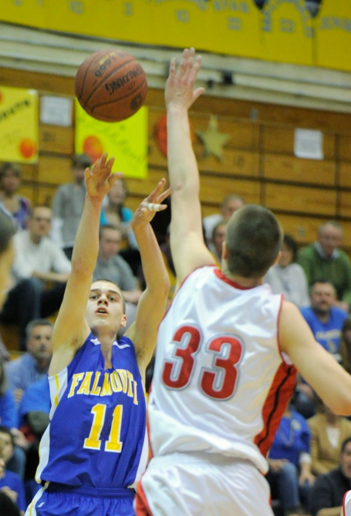 Ryan Rogers of Falmouth launches a shot over Keegan Pieri of Camden Hills during Falmouth’s 72-65 overtime victory in the Class B state final at Bangor.