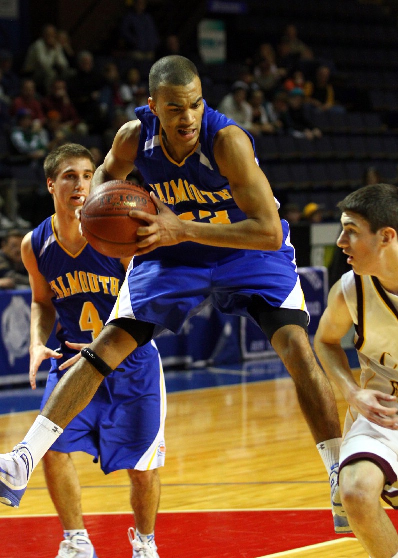 Jahrel Registe of Falmouth pulls down a rebound in front of Cape Elizabeth's Cam Brown during the Western Class B championship game at the Cumberland County Civic Center. Falmouth knocked off the two-time regional champions, 53-40.