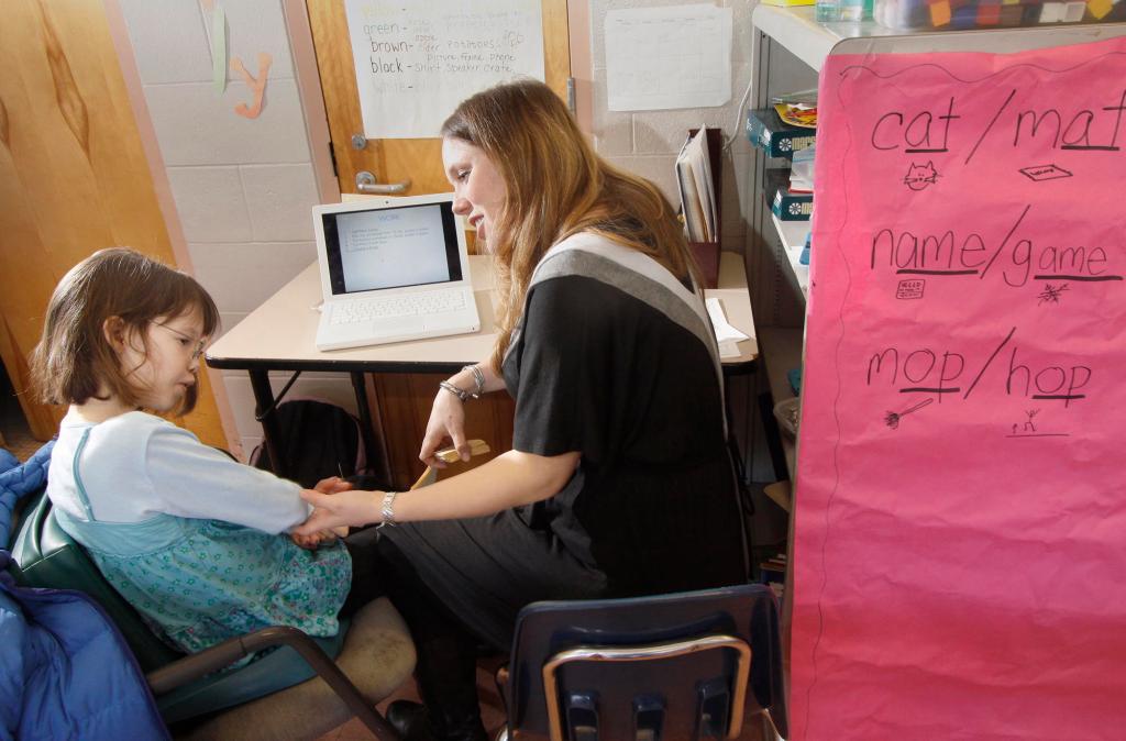 Special education teacher Paige Fournier works with Emily Martin at Moore Middle School in Portland. Emily’s parents praise Fournier for seeing Emily as a person who can learn.