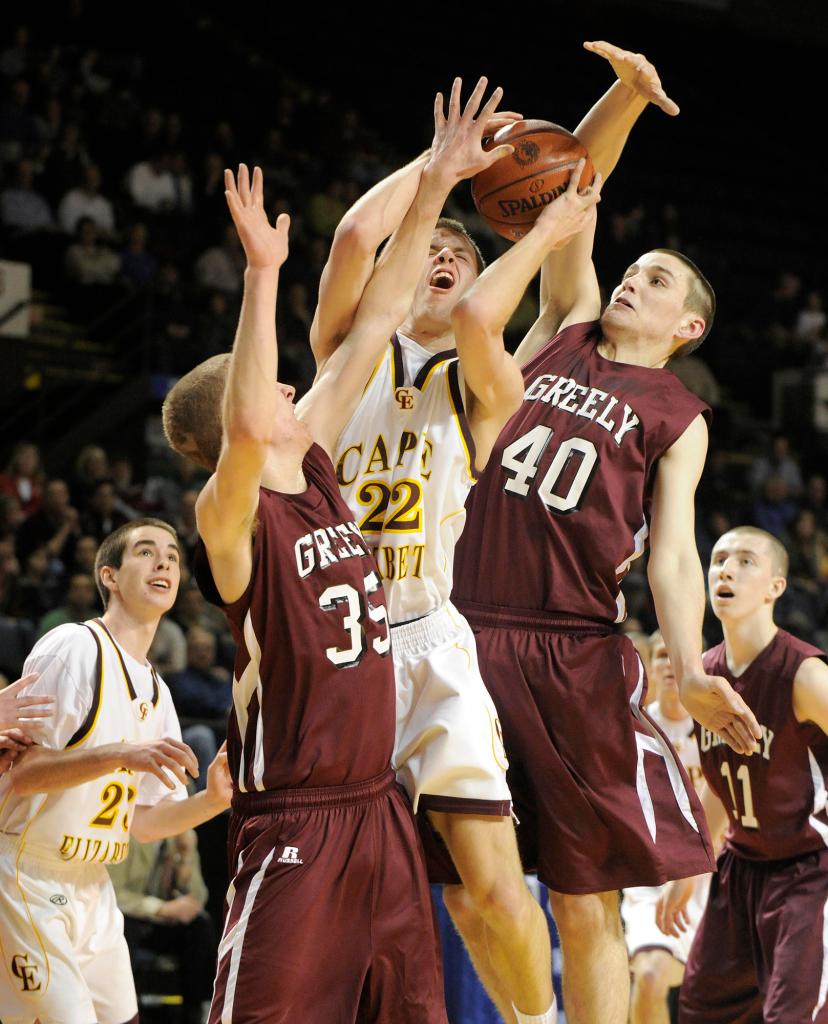 John Ewing/Staff Photographer Andrew Dickey of Cape Elizabeth gets squeezed by Trevor Tierney, left, and Tanner Storey of Greely while shooting Thursday night during the Western Class B semifinals at the Civic Center. The Capers won, 51-43.