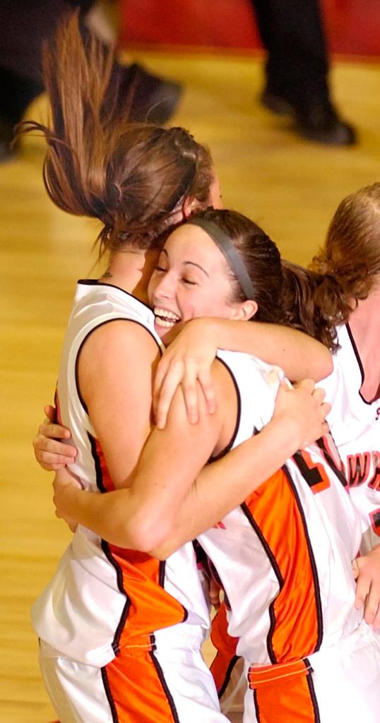 Staff photo by Joe Phelan Skowhegan senior forward Mackenzie Smith, left, hugs senior guard Liz Noddin right after Noddin sank a last second shot to win the Eastern Maine Class A regional girls basketball championship Friday at the Augusta Civic Center over Brunswick by a score 38-36.