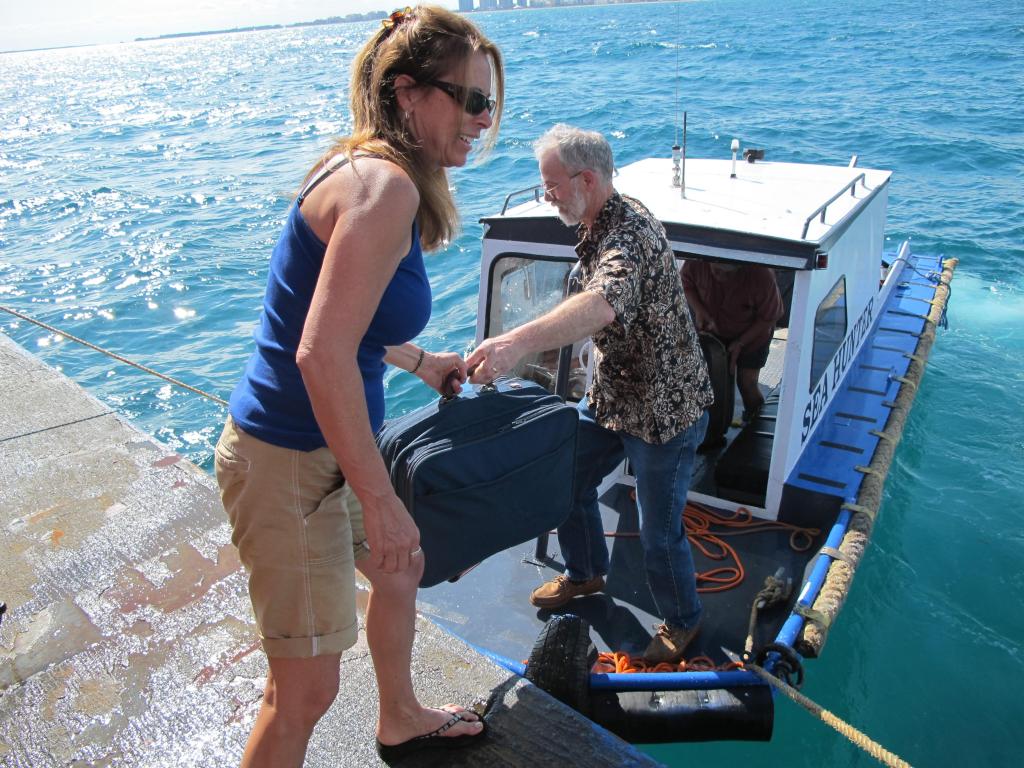 Ship’s cook Cindy Hart welcomes shipmaster Kevin Garthwaite of Wells aboard the Sea Hunter off Miami’s South Beach on Sunday afternoon.