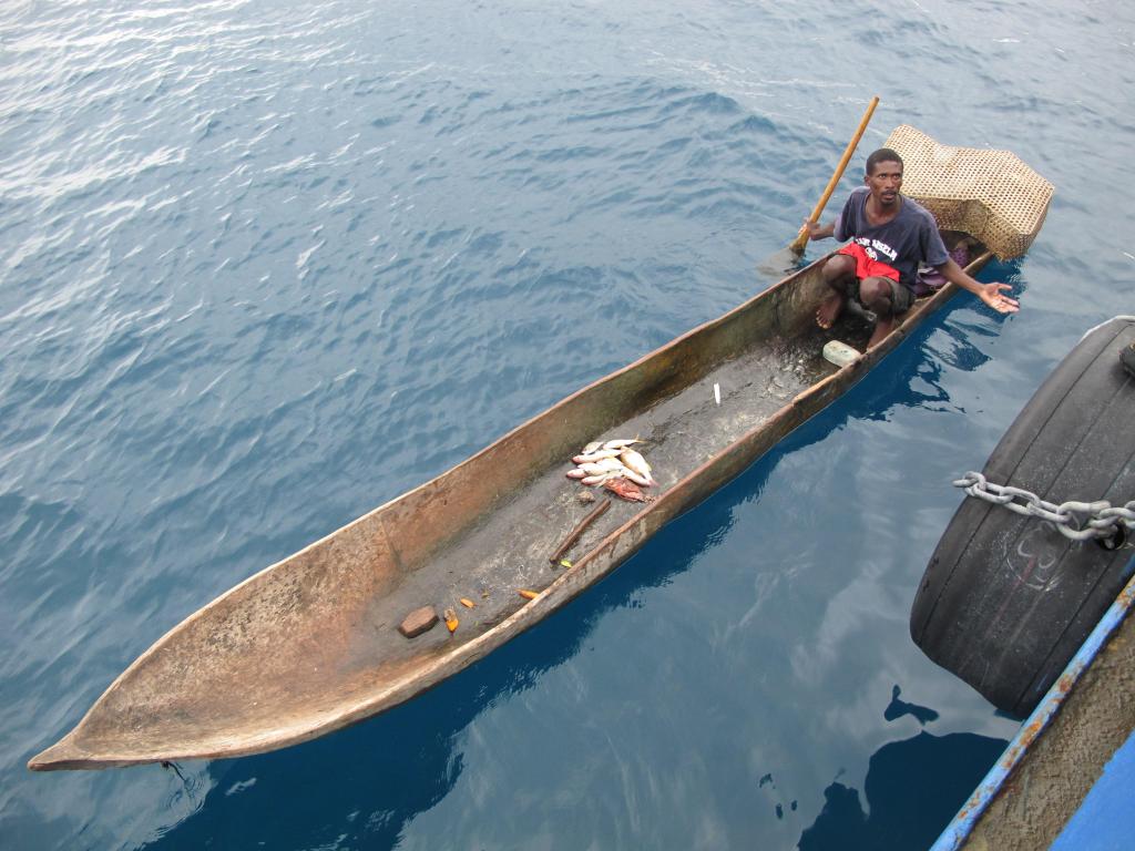 A fisherman from the Haitian port of Miragoane peddles his catch Saturday morning alongside the Sea Hunter. The ship’s owner has been trying since Thursday to unload his cargo.