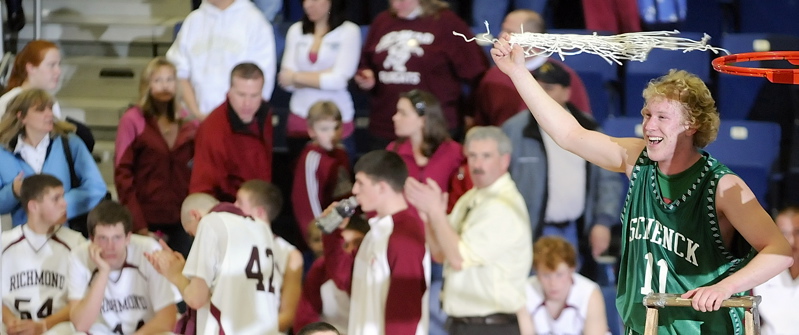 Cody LeVasseur twirls the net as Schenck celebrates a 65-43 win over Richmond in the Class D boys' basketball state championship game.