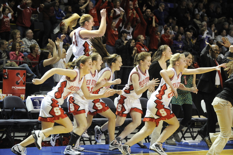 Scarborough players rush onto the court following their come-from-behind win over Deering.