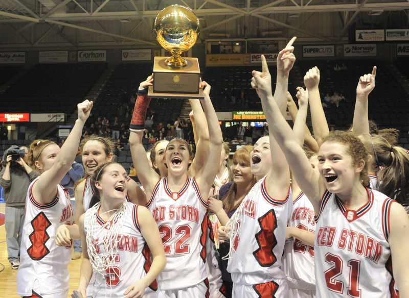 Jenn Colpitts of unbeaten Scarborough raises the Gold Ball – a first for the school in girls’ basketball – after the 52-32 victory against Skowhegan at the Cumberland County Civic Center.