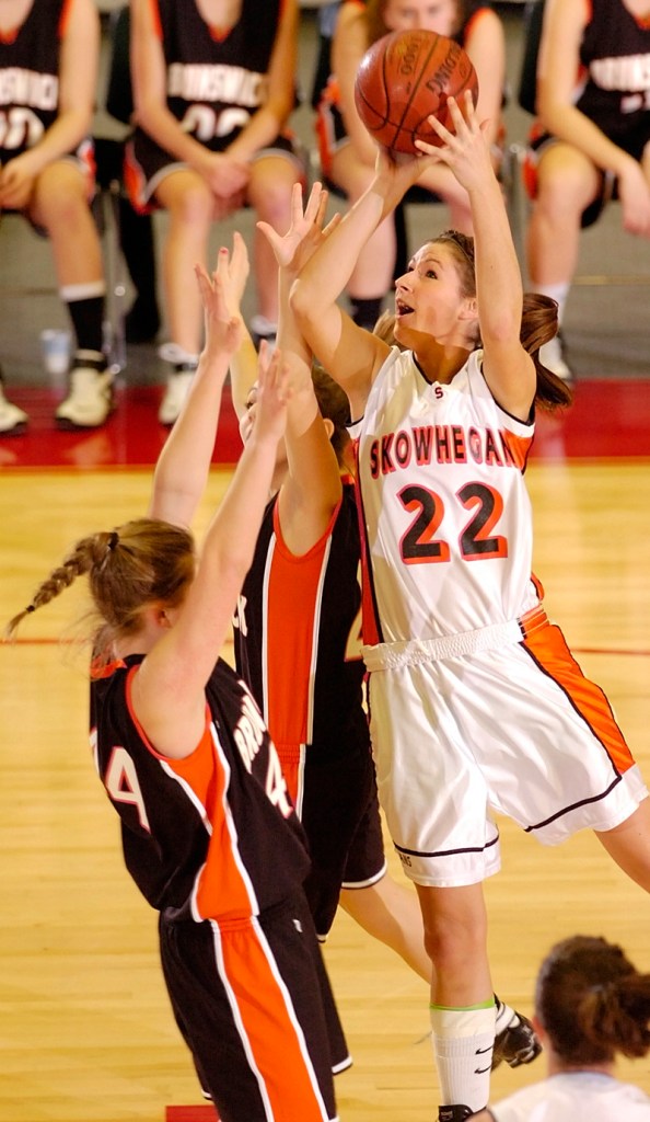 Mackenzie Smith of Skowhegan shoots over Emily Bryant, left, and Becky Champagne.