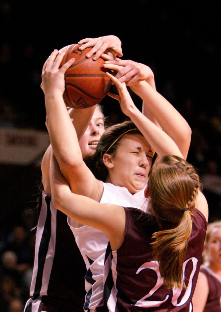 Marquis MacGlashing of York is double-teamed by Nicole Faietta, front, and Abby Young.