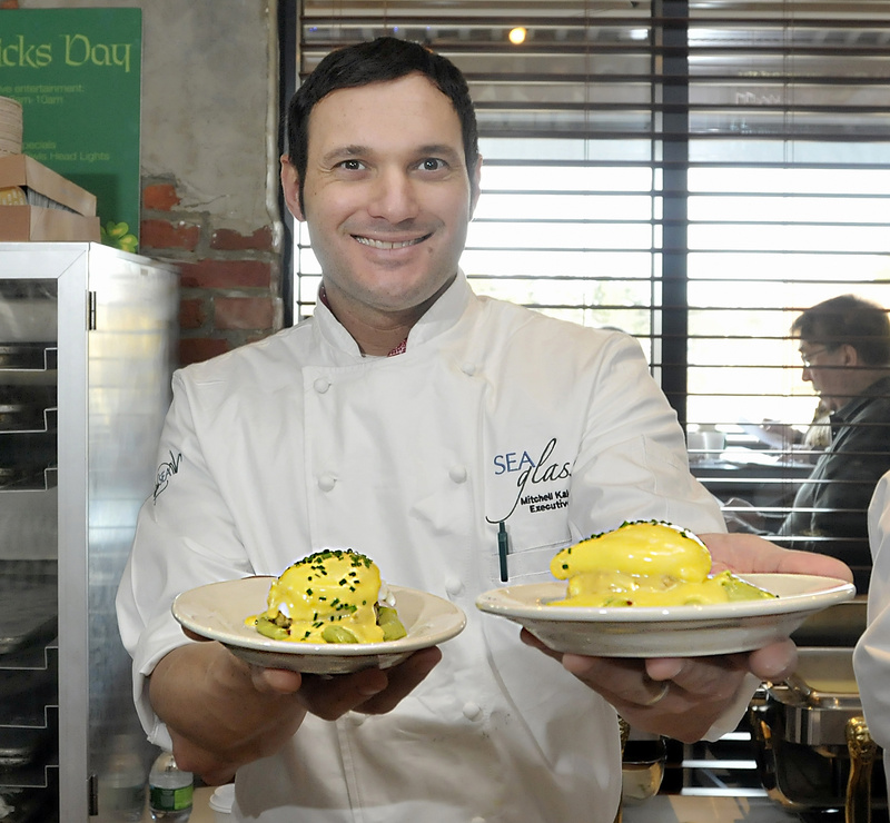 Chef Mitchell Kaldrovich of the Sea Glass Restaurant at the Inn by the Sea in Cape Elizabeth offers his creation, crab Benedict, to guests at the breakfast cook-off.