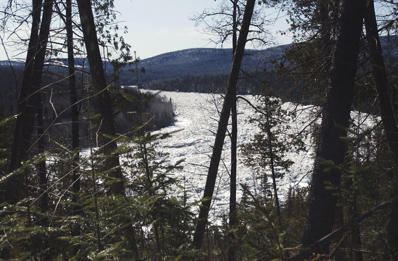 Clogged with ice, the St. John River flows through woods in the Aroostook County town of Allagash.