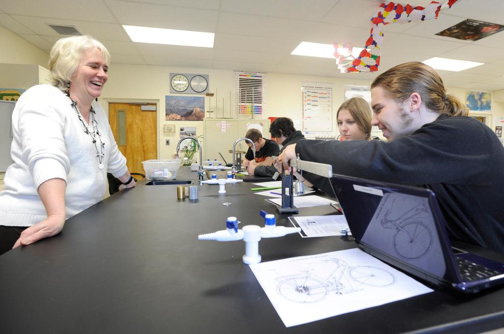 Physics teacher Cori Cost watches Beata Hechtova and Joshua Warren at Forest Hills Consolidated School in Jackman. Warren plans to study computer graphics technology at Southern Maine Community College.