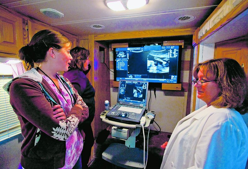 Nursing and counseling volunteers await their next client on board a donated RV parked outside the Imperial Courts housing project in the Watts section of Los Angeles. The evangelical Christians bring free pregnancy detection and counseling services to low-income communities in the Los Angeles area in efforts to reduce the incidence of abortion.