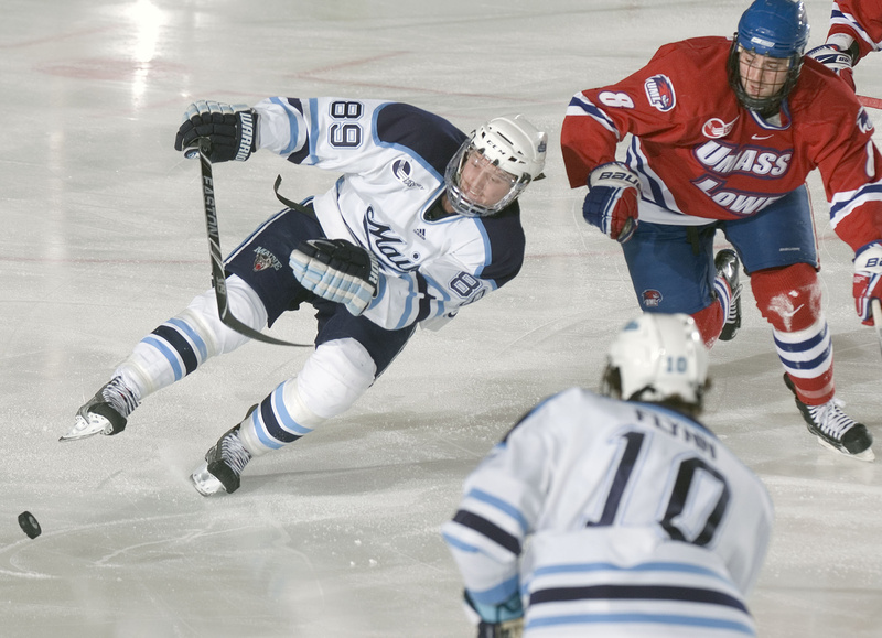 Gustav Nyquist loses his balance while going for the puck Sunday night in Maine’s win over UMass-Lowell.
