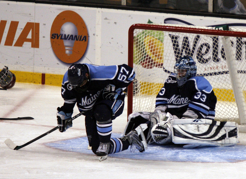 Matt Mangene and goalie Dave Wilson of the University of Maine absorb what just happened Saturday night immediately after Boston College scored the overtime goal that won the Hockey East title and brought the Black Bears’ season to an end.