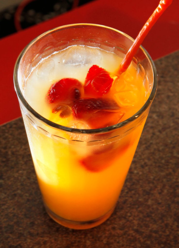 Jo Moser’s orange spritzer, made with frozen strawberries and blueberries, seltzer water and fresh-squeezed orange juice.