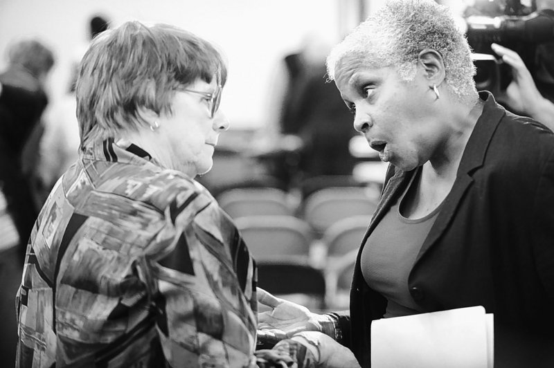 Barbara York, left, who admitted forwarding an inappropriate e-mail, talks with Mary-Vienessa Fernandes after a meeting Tuesday at which York was censured.