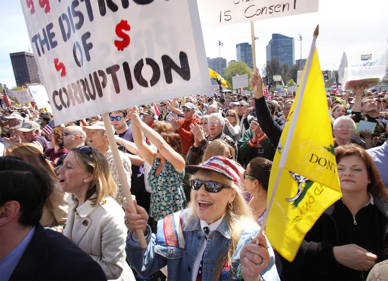 Marilyn Flynn, center, of Poland, Maine, cheers as former Alaska Gov. Sarah Palin takes the stage at the Boston tea party rally. Mainers who traveled to the rally on two buses said they enjoyed meeting “like-minded” people.