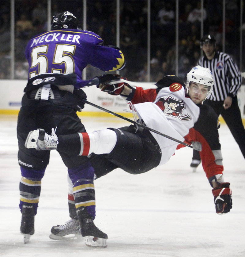 David Meckler of the Monarchs levels Portland’s T.J. Brennan in the second period. Manchester lost 7 of 10 to the Pirates in the regular season.