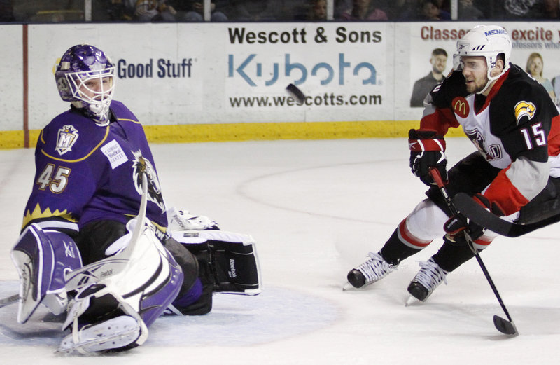 Manchester goalie Jonathan Bernier blocks a shot as Portland’s Felix Schutz cruises in looking for a rebound opportunity during their playoff game Saturday night at the Cumberland County Civic Center. The Monarchs beat the Pirates 3-1 for a 2-0 series lead.