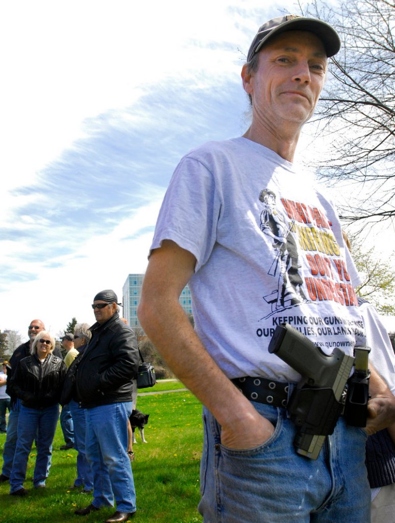 Cory Mills of Biddeford displays his Springfield Armory XD45 at the Back Cove event.