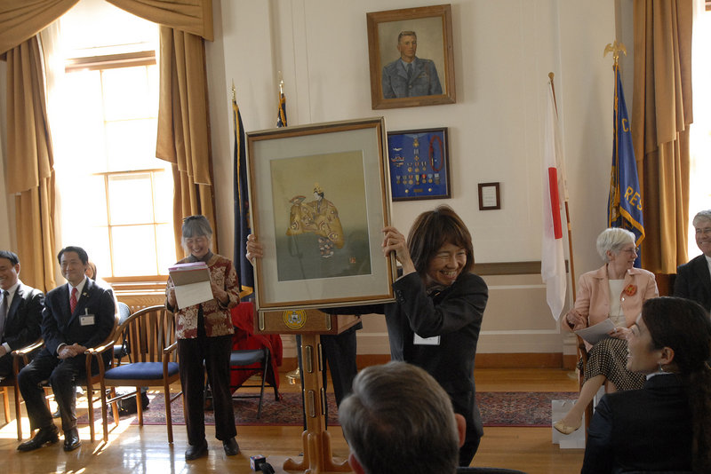 Takeshi Hamano, mayor of Shinagawa, Japan, steers the ferry Monday during a trip to Peaks Island. With him are dignitaries from Portland's sister city along with former Mayor David Brenerman, in dark coat, and Tom Morse, right, a relative of Edward Sylvester Morse, who is honored in Japan.