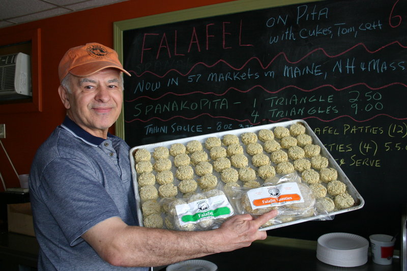 Chris Zoulamis shows off a tray of kosher-certified frozen falafels at his Papou’s Kitchen facility in Portland. The company is one of a handful in Maine that have received certification from the newly formed Maine Kosher Vaad.