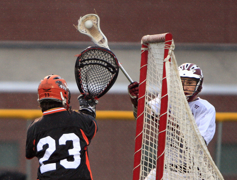 Paul Witte of Greely looks for an opening Tuesday night as North Yarmouth Academy goalie Taylor Norton defends. Witte had a goal and an assist but it wasn’t enough to prevent NYA from earning a 10-7 victory.