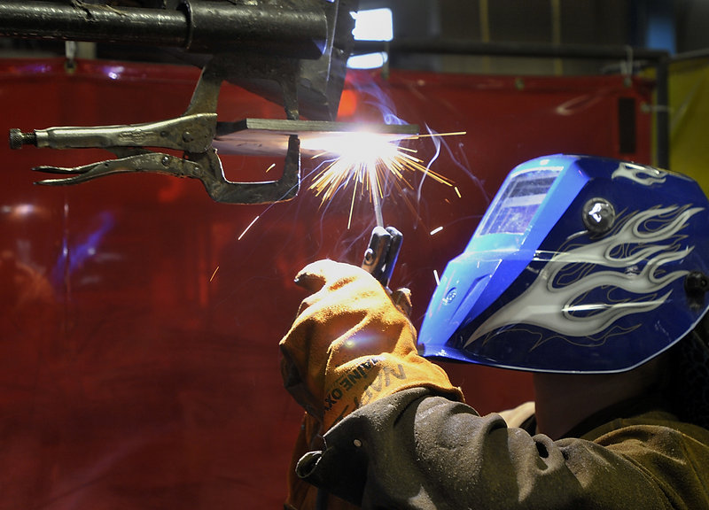 Joe Nappi of Scarborough performs an “overhead weld" during a national certification welding exam at the Portland Arts and Technology High School.