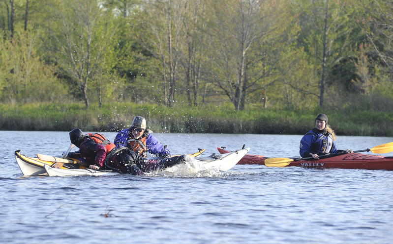 Outdoor writer Shannon Bryan, on right, gets kayak instructions from Theresa Ouellette of Coastal Maine Kayak and fellow guide Ernie Forgione on the water at Highland Lake in Falmouth.