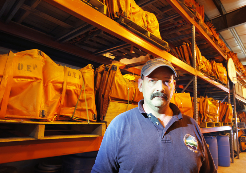 Stephen Flannery, an oil and hazardous materials specialist with the Maine Department of Environmental Protection, says the state will be sending down 5,700 feet of 24-inch fence boom, seen behind him at the DEP’s Portland warehouse Tuesday, to help crews clean up the oil spill in the Gulf of Mexico.