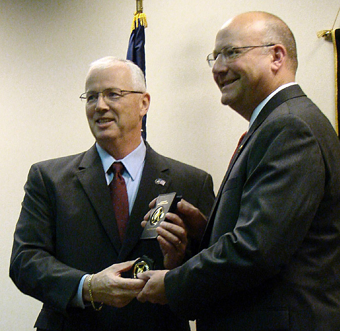 John Clark, left, director of the U.S. Marshal Service, swears in Noel March as Maine's U.S. marshal.