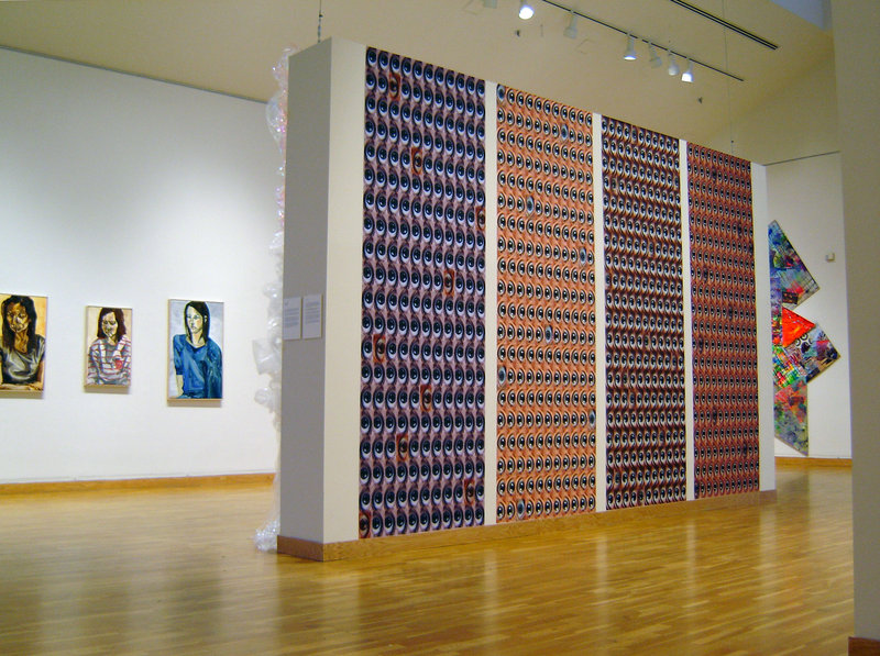 The view of the senior exhibition at the Bates College Museum of art shows, from left, portraits by Emma Sprague, photography by Lisa Hartung and painting by Elizabeth Denham.