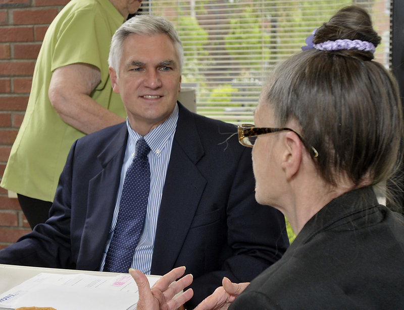 Steven Rowe, candidate for governor listens to the concerns of Joane Dickinson as he talks to residents of 100 State Street.