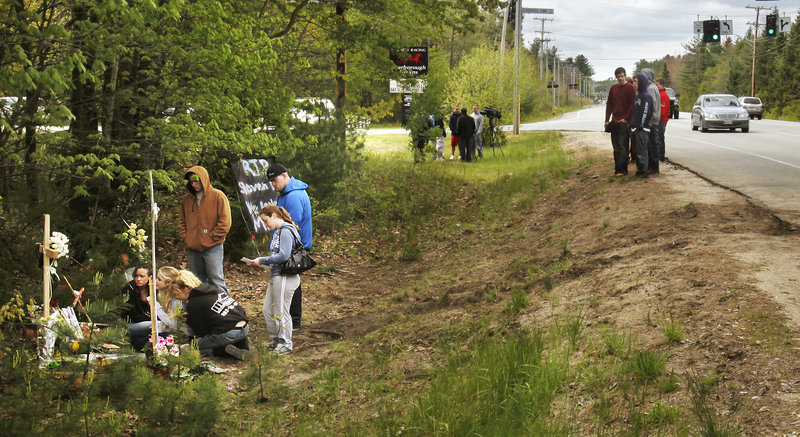 Scarborough High School students gather Monday at the site of a crash at Payne and Holmes roads that killed Steven Delano on Saturday night. “For many of them, it’s the first time they have experienced such a loss,” said Patricia Conant, Scarborough High principal.