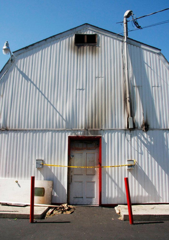 Police tape blocks access to the rear entrance of Red’s Dairy Freeze. Sunday’s fire charred parts of the building’s exterior.