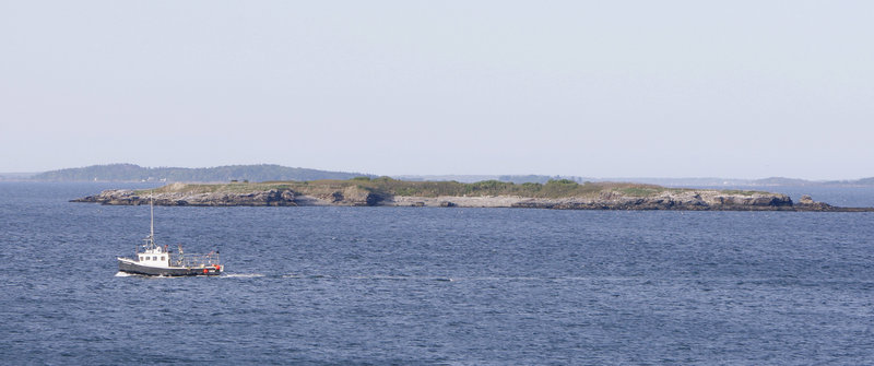 A fishing boat passes Ram Island in Casco Bay on Monday. Irina McEntee and Carissa Ireland made a kayak trip to the island Sunday from Peaks Island, but never made it home. A caretaker on a nearby island was one of the last people to see them alive.