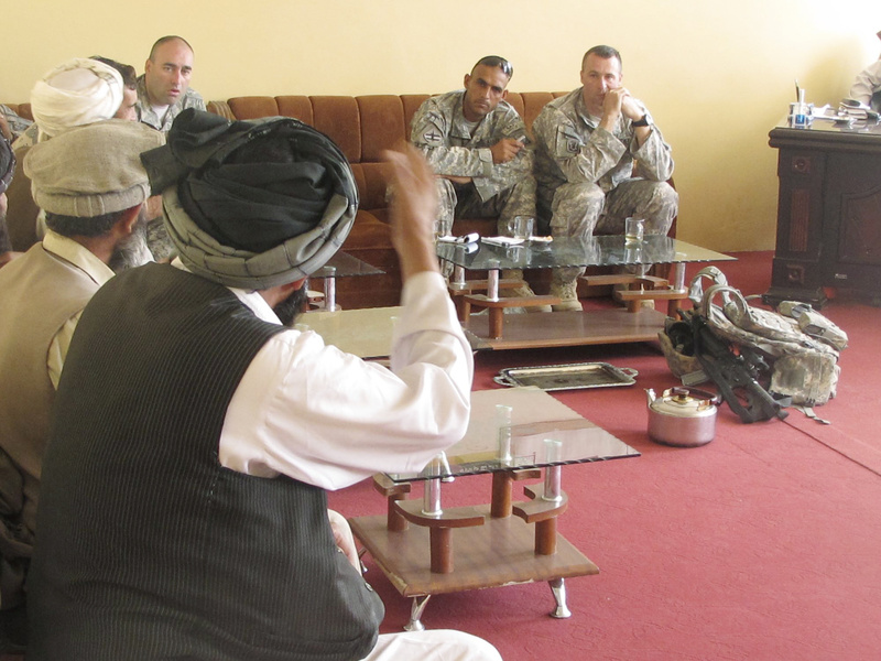 A local elder makes a point Monday to Bravo Company commander Capt. Paul Bosse of Auburn, who is aided by an Army interpreter. The American officer listened for 40 minutes before taking his turn to speak.