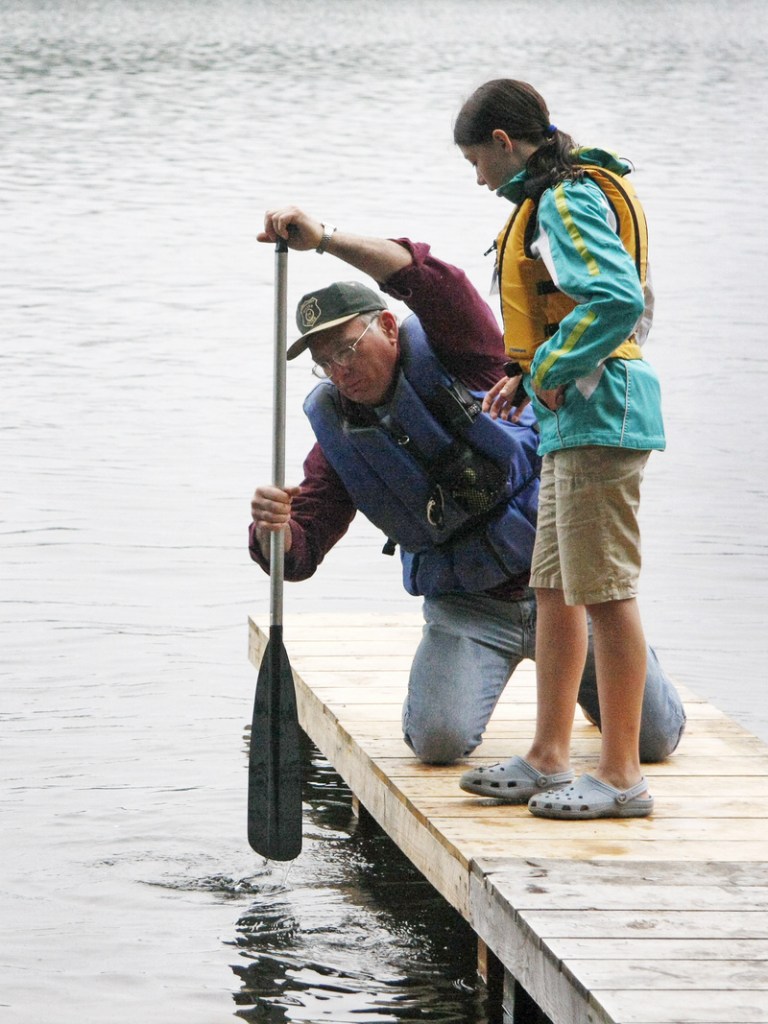 Terry Moulton shows Grace Andrews of Farmington how to make her paddle stroke more effective.