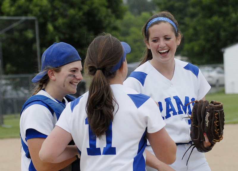 From left, Janelle Bouchard, Hannah King and Kelly King celebrate after completing the regular season Wednesday with a 3-2 victory over Biddeford.