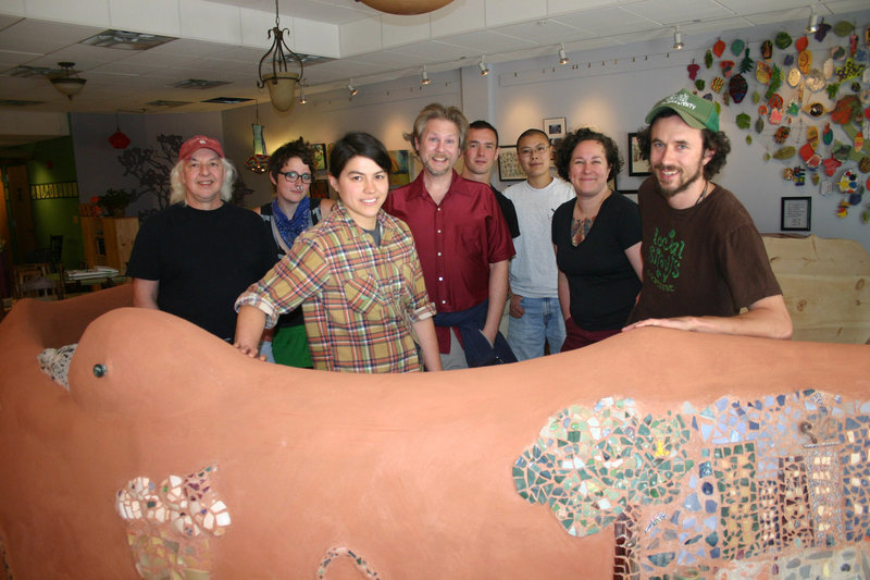 Meara Smith, front left, the kitchen coordinator, and Jonah Fertig, front right, a founder of Local Sprouts, stand in the new cafe with fellow workers and worker-owners Barry Manson, Jazz Aden-Wood, David Ladd, Tim Powers-Wilson, Queena Lo and Heather Blersch.