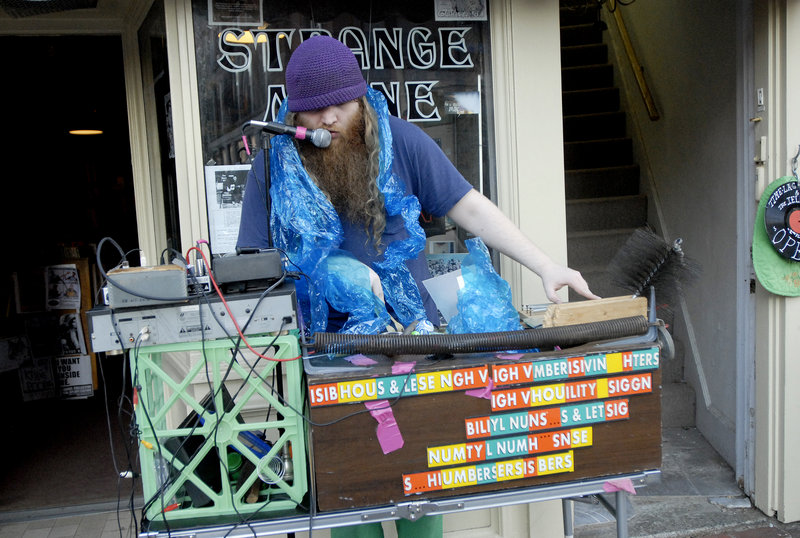 A performer who goes by the name Scott performs with a box of assembled stuff including a file, back scratcher and a chimney sweep.
