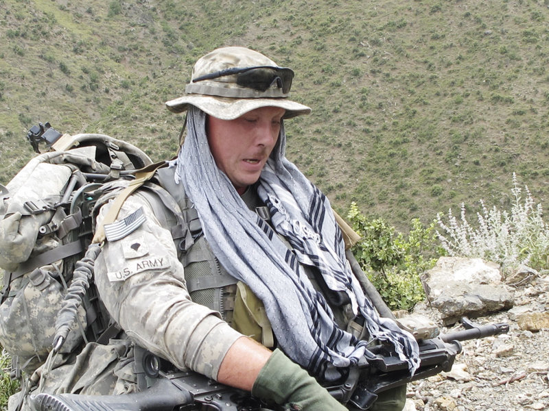 Spc. Jason McFarland of Chelsea takes a break from the uphill climb with his 150-pound load that included a machine gun, tripod, ammunition and other gear.