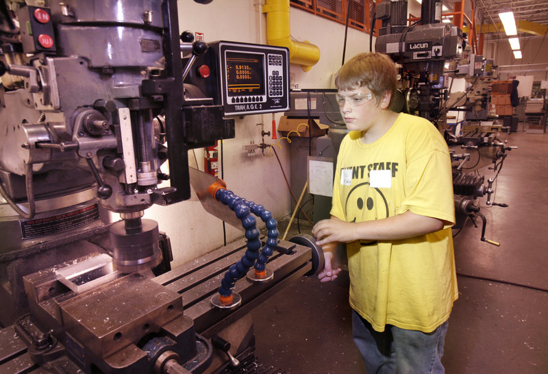 Nick Busque mills an aluminum block at Southern Maine Community College in South Portland on Wednesday as part of a week-long camp for teenagers interested in learning welding, machining and related manufacturing skills.