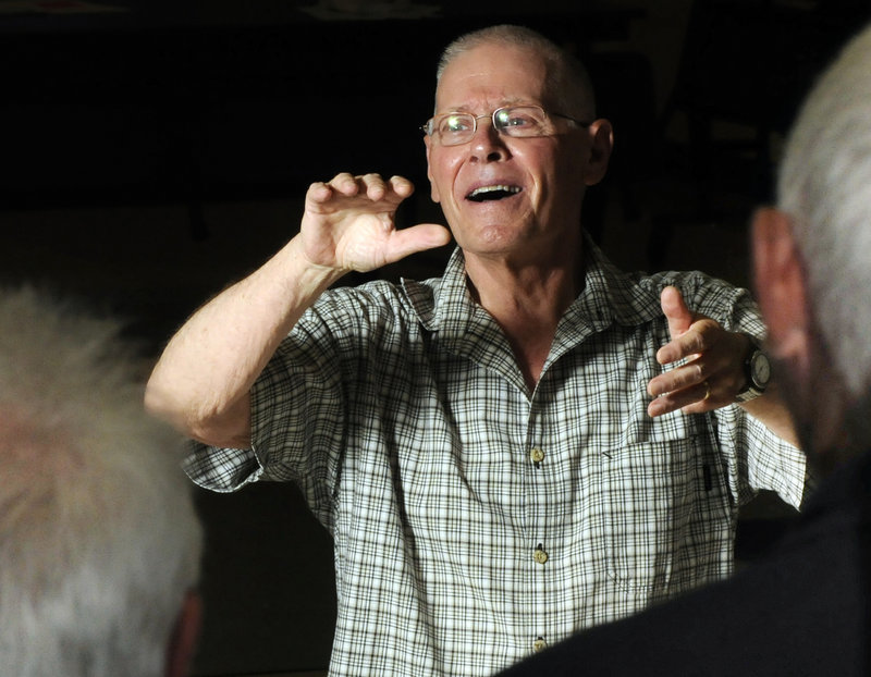 Chorus director Jack Baggs conducts the singers.