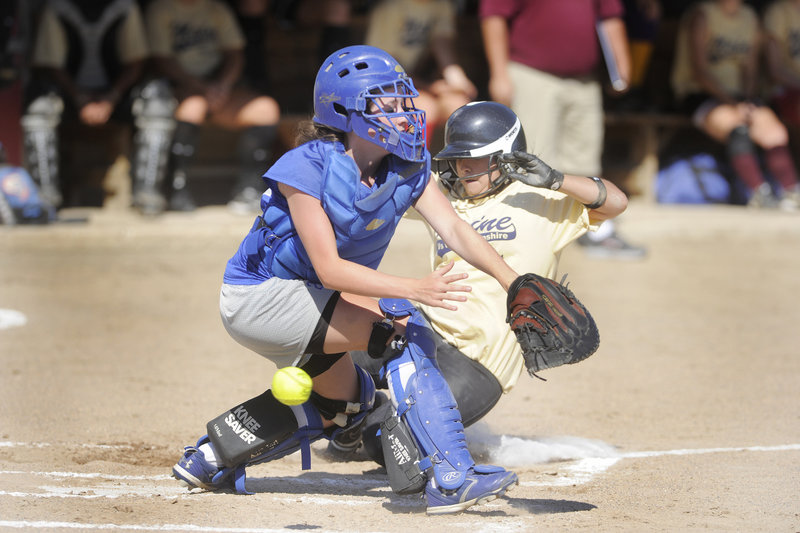 Hillary Oleson of Gorham, N.H., can't handle the throw as Denise Freitas of Sanford slides in to score Tuesday during Maine's 10-1 victory in a senior all-star game.