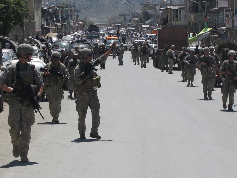 Staff Sgt. Anthony Marson of Richmond waves to onlookers Saturday as the Maine Army Natonal Guard’s Bravo Company marches for the first time through the Afghan village of Chamkani.