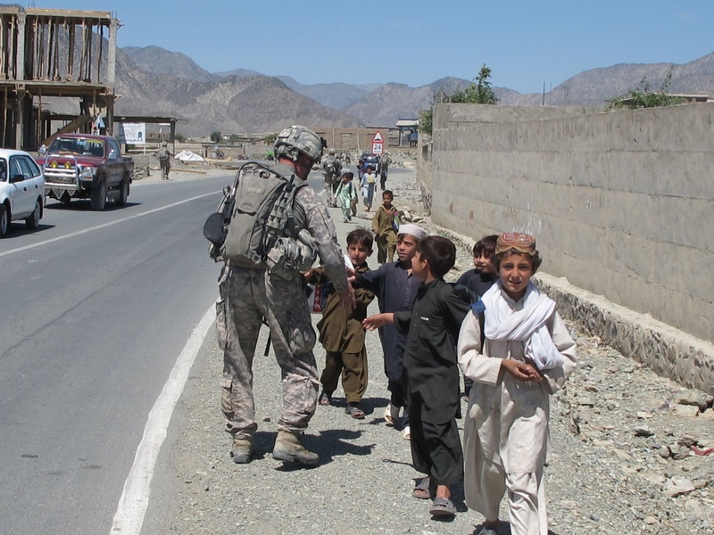 Capt. Paul Bosse of Auburn shakes hands with local boys.