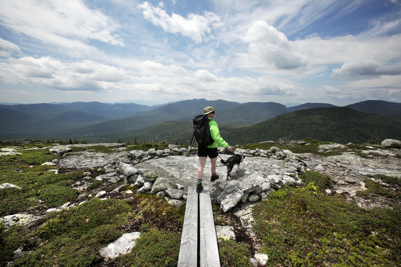 Reporter Deirdre Fleming walks out to an outlook on Sunday River Whitecap while hiking the Grafton Loop trail in Newry.