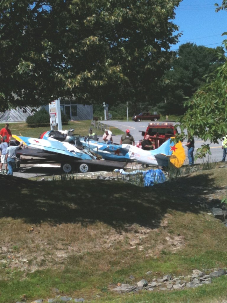 Workers load the plane that crashed Saturday at the Portland International Jetport onto a flatbed attached to a trailer today on Western Avenue in South Portland.